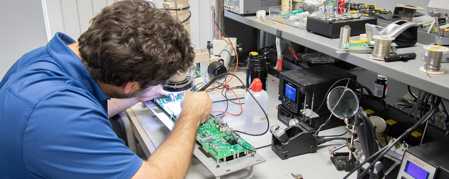 A technician working on complex machinery
